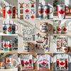 Tumblers and mugs displayed on a shelf with Canadian leaf and flag designs on the cups, mugs, and t-shirts.