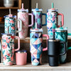 Personalized designed tumblers on a stand showing off their vibrant color.