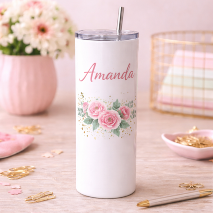 White stainless steel tumbler with metal straw featuring the words “Your Design Here,” placed on a neutral surface with plants and a lemon slice in the background.