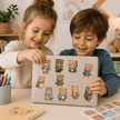 Two children playing with bear stickers on a laptop in a classroom setting.