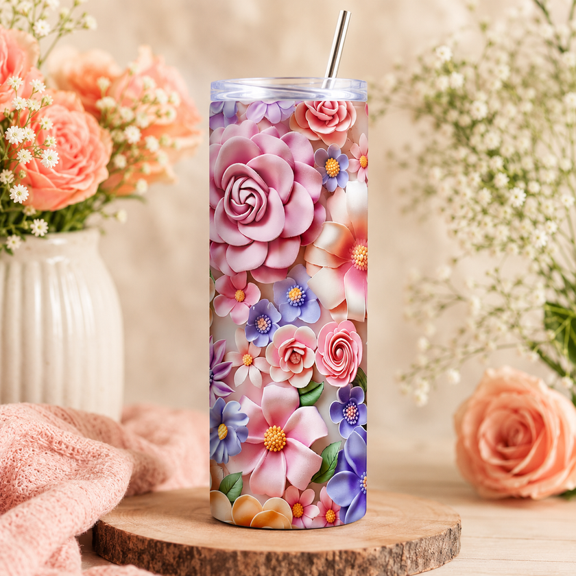 Tumbler with floral design on a wooden surface with flowers in the background