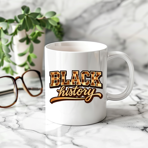Ceramic Black History mug on marble counter beside glasses and plant in modern home setting.