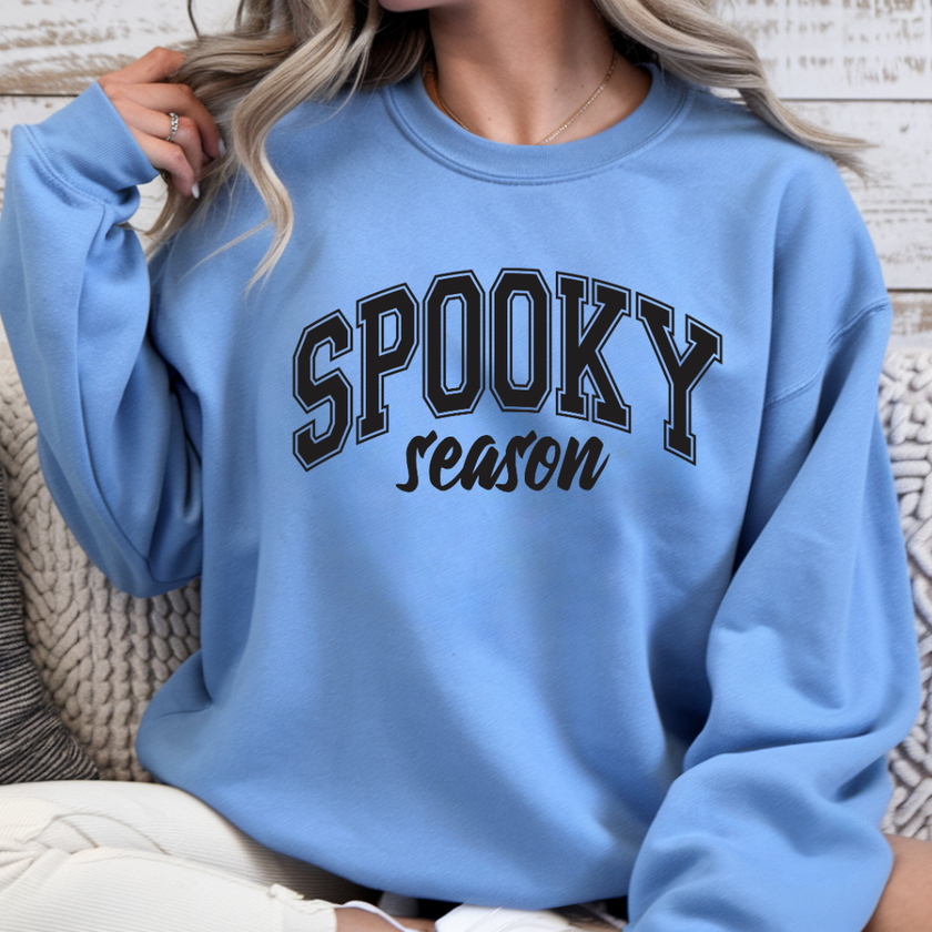 Carolina blue Spooky Season crewneck sweatshirt with black collegiate graphic for Halloween lovers and autumn wear
