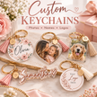 Custom photo keychains displayed on a marble surface with pink roses and a gift box in the background. The keychains include round, heart, and square acrylic designs with gold-tone hardware, pink tassels, and customizable text or pet portraits.