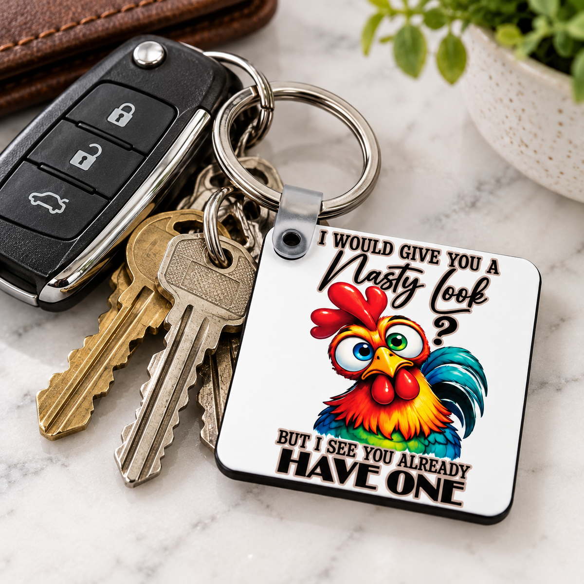 Funny chicken keychain hanging with car and house keys featuring a colourful rooster and sarcastic nasty look quote.