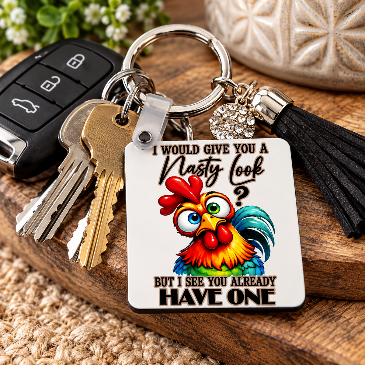 Colourful chicken lover keychain on a wooden surface with bright cartoon rooster artwork and humorous sarcastic quote.