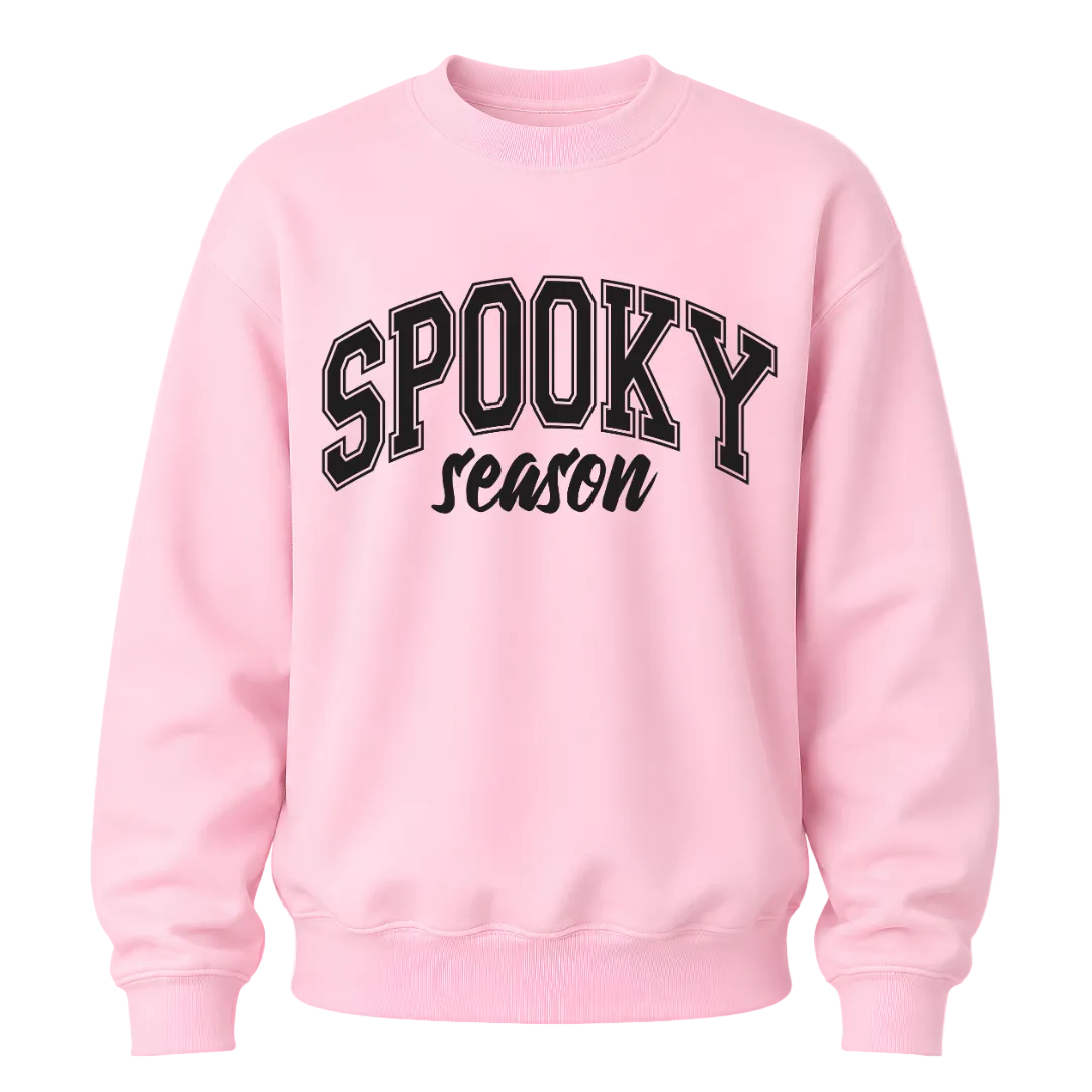 Light pink Spooky Season crewneck sweatshirt featuring black collegiate Halloween lettering for women and fall outfits