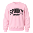 Light pink Spooky Season crewneck sweatshirt featuring black collegiate Halloween lettering for women and fall outfits