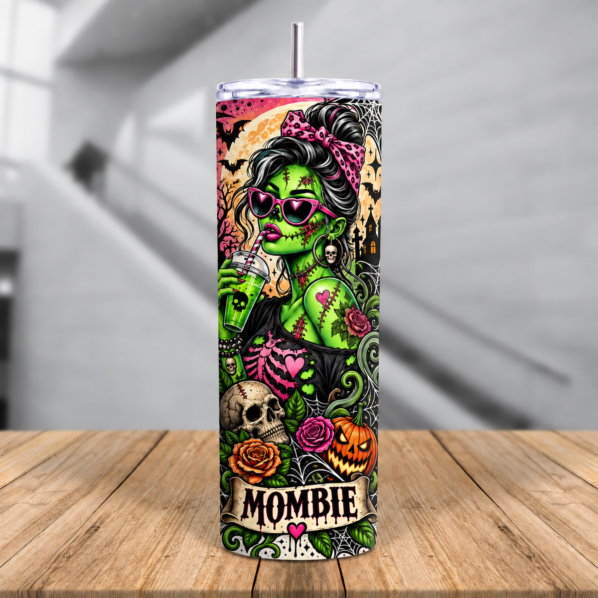 Spooky mom Halloween tumbler with Mombie character holding a green drink surrounded by pumpkins, skulls, roses and spider webs.