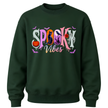 Youth Spooky Vibes Halloween crewneck available in seasonal colours with colourful pumpkin, ghost, raven, black cat and bat design.