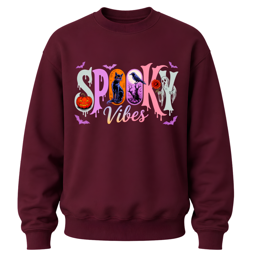 A maroon crewneck sweatshirt featuring a colorful 'Spooky Vibes' graphic on the chest with Halloween-themed illustrations.