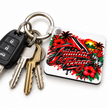 Trinidad and Tobago keychain attached to house and car keys featuring red black and white flag colours, hibiscus flowers and tropical island artwork.