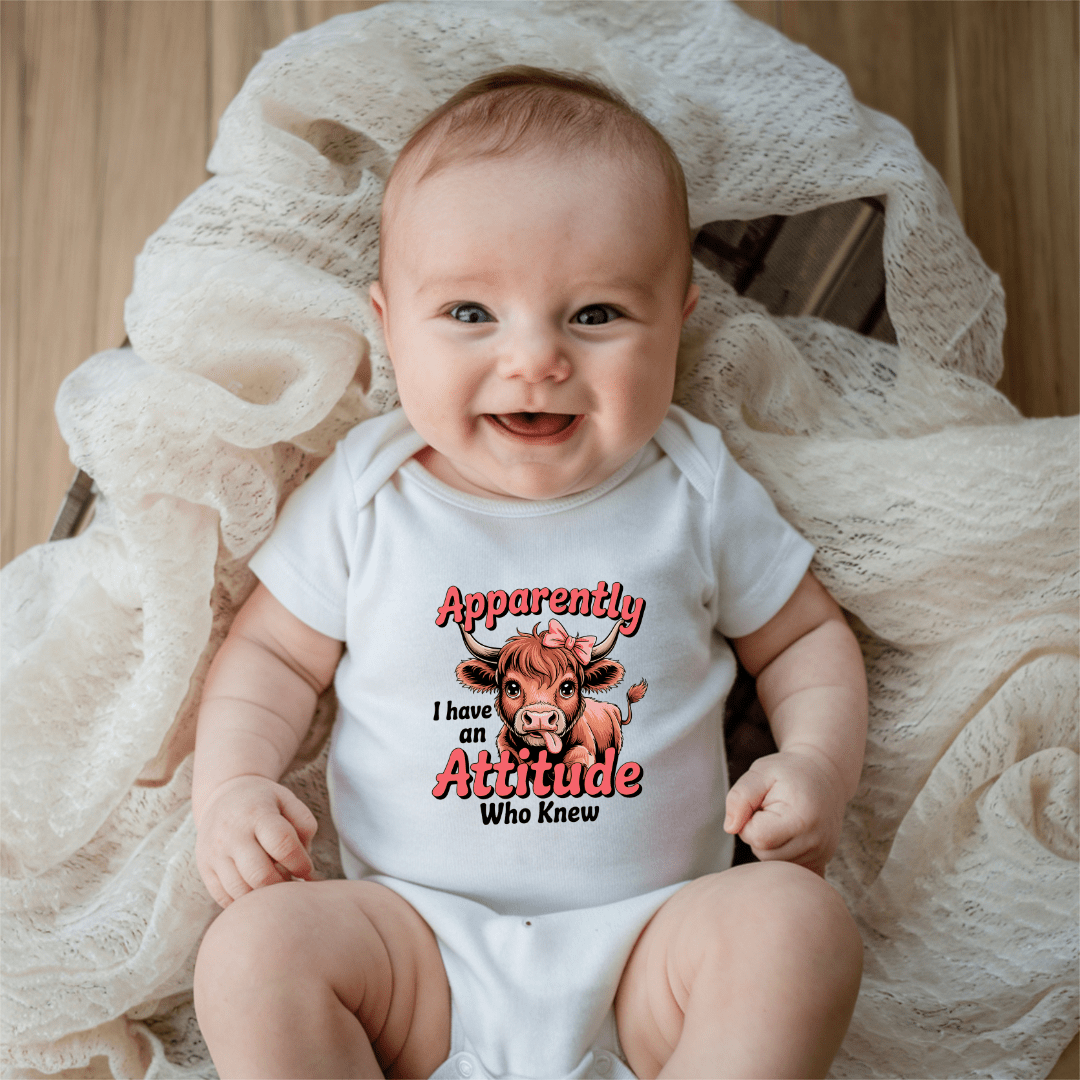 baby wearing funny onesie with apparently i have an attitude text design