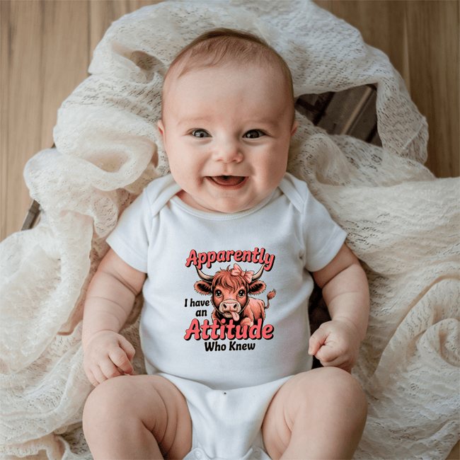 baby wearing funny onesie with apparently i have an attitude text design