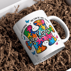 autism awareness be kind mug with colorful puzzle artwork placed in gift box