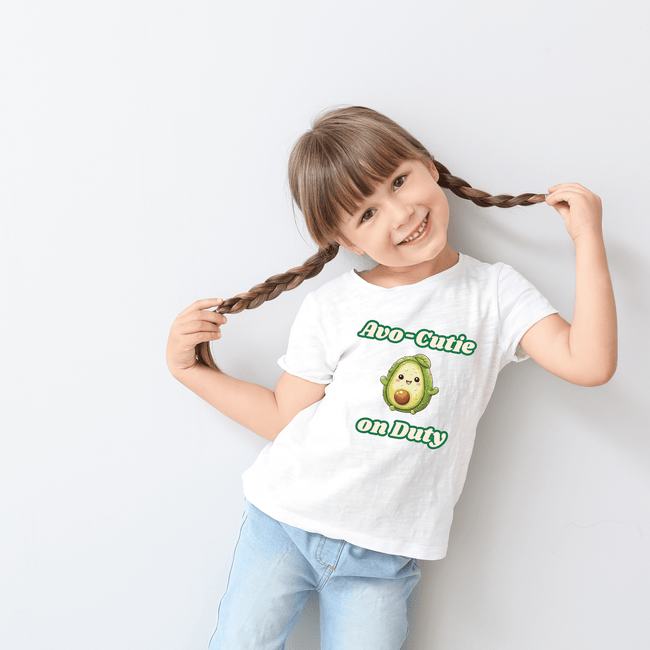 White t-shirt featuring adorable avocado design with fun “Avo-Cutie On Duty” lettering.