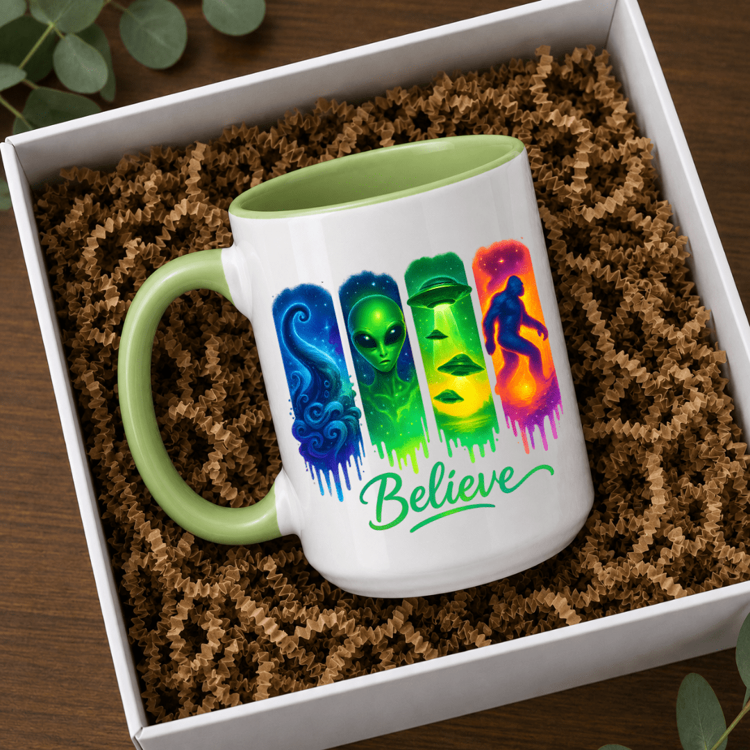 Green accent Believe alien UFO Bigfoot mug displayed in a gift box, perfect for cryptid and paranormal enthusiasts.