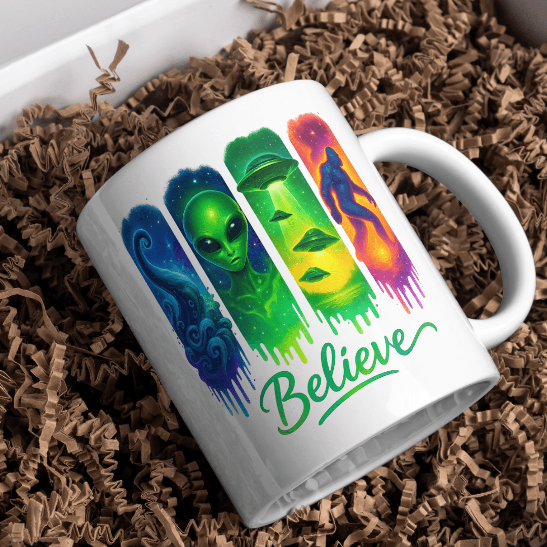White Believe paranormal coffee mug featuring an alien, UFO, mysterious tentacle and Bigfoot in vibrant cosmic colours.