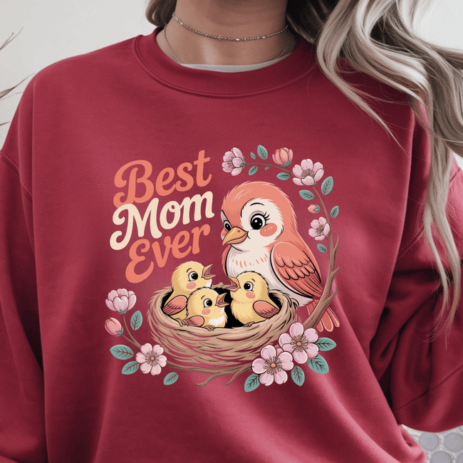 Red crewneck with bright illustrated birds and pink floral frame.