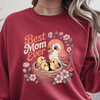 Red crewneck with bright illustrated birds and pink floral frame.
