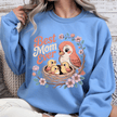 Carolina blue crewneck with cute bird nest design and decorative flowers.