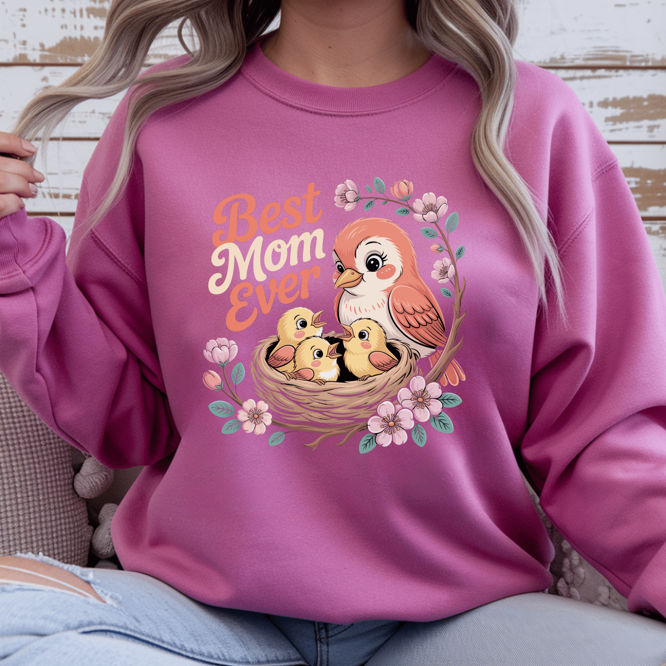 Heloncia pink crewneck with cheerful floral bird design.