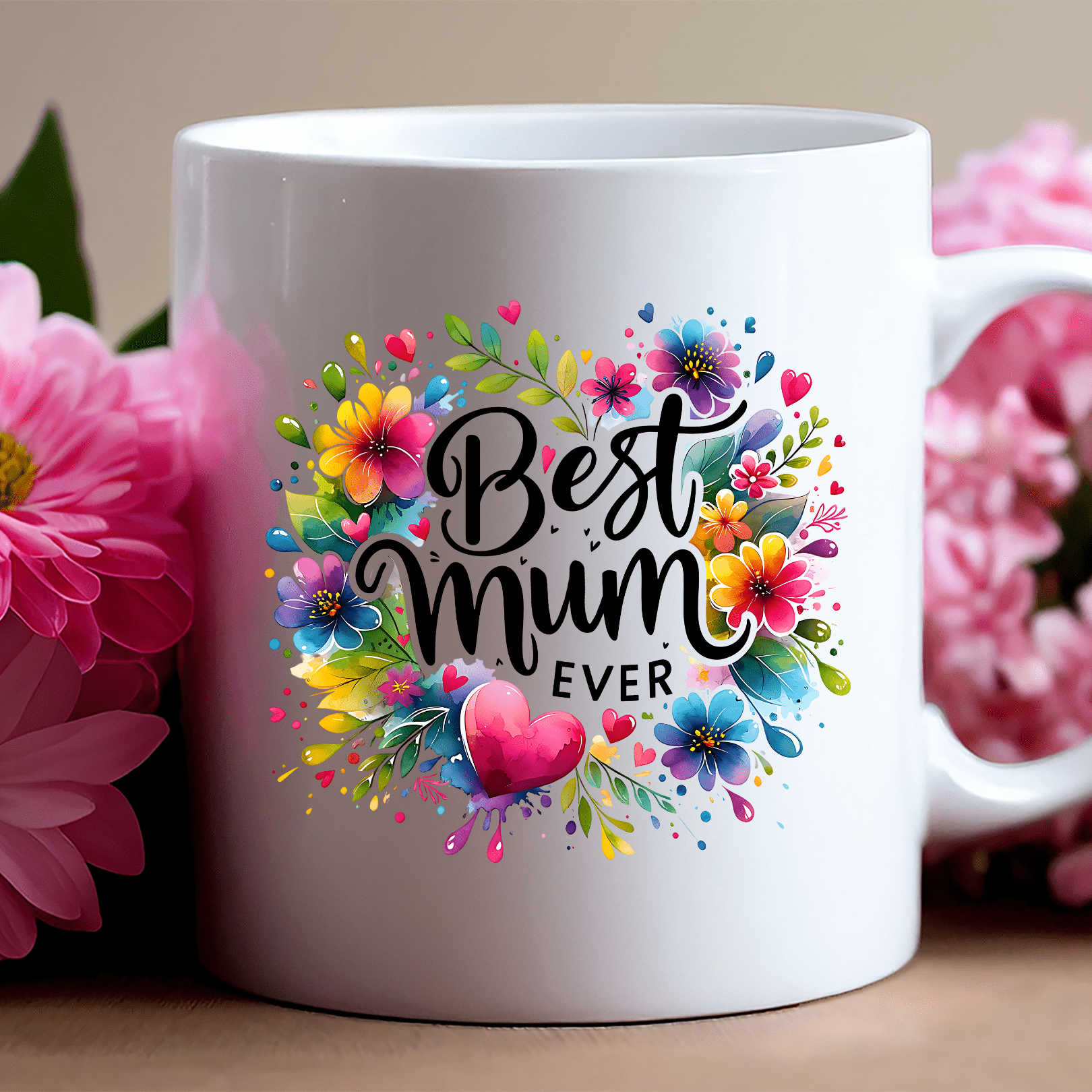 White mug with 'Best Mum Ever' text and floral design, surrounded by pink flowers.
