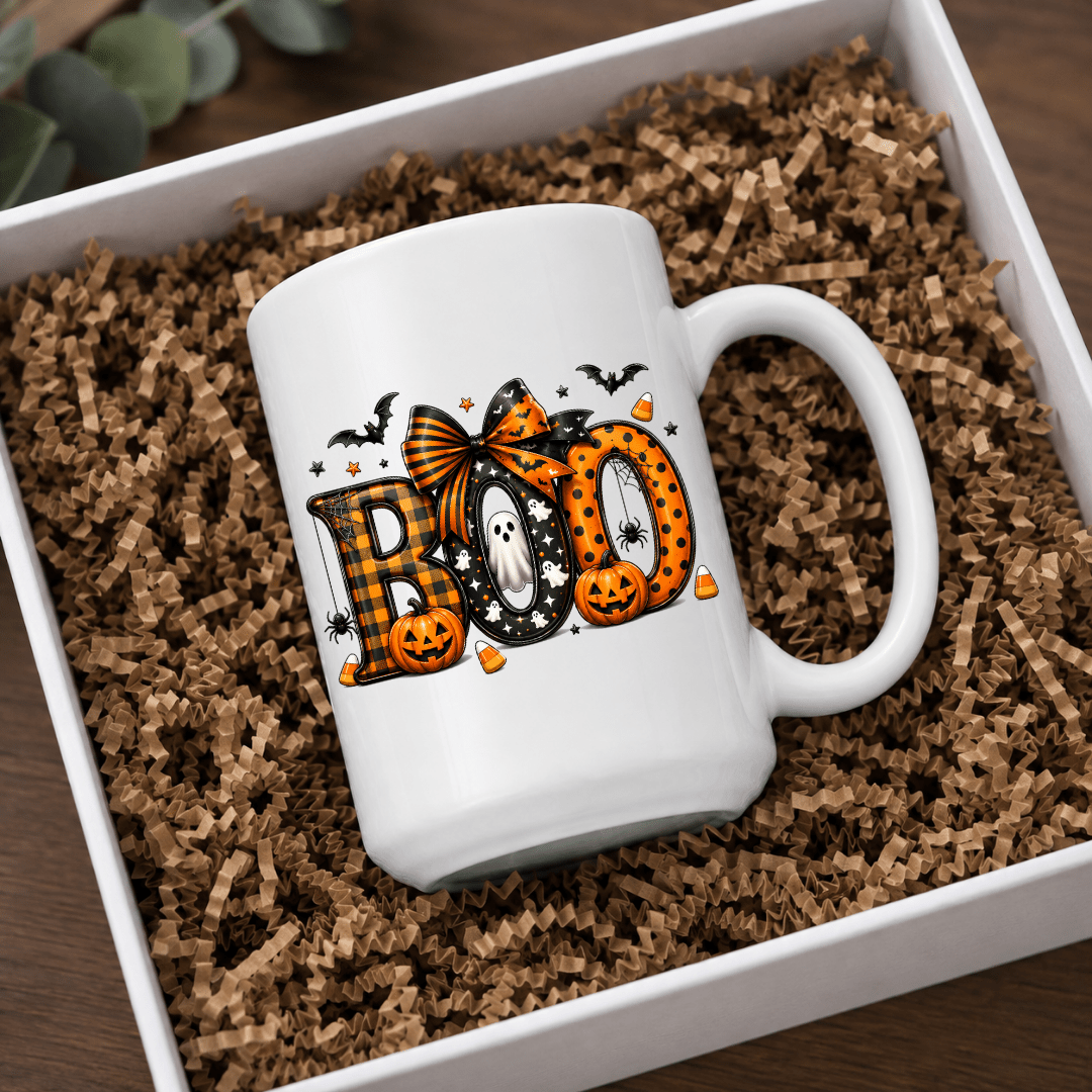 White ceramic BOO Halloween mug with pumpkins, ghosts, bats and candy corn in a cozy seasonal product mockup