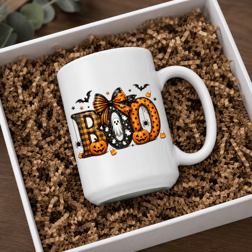White ceramic BOO Halloween mug with pumpkins, ghosts, bats and candy corn in a cozy seasonal product mockup