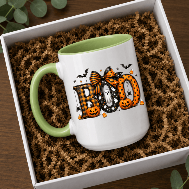 Green accent Halloween mug with BOO lettering, pumpkin details and ghost artwork styled in a gift box setting