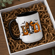 Black accent Halloween mug with bold BOO artwork and seasonal fall graphics presented in a premium boxed mockup