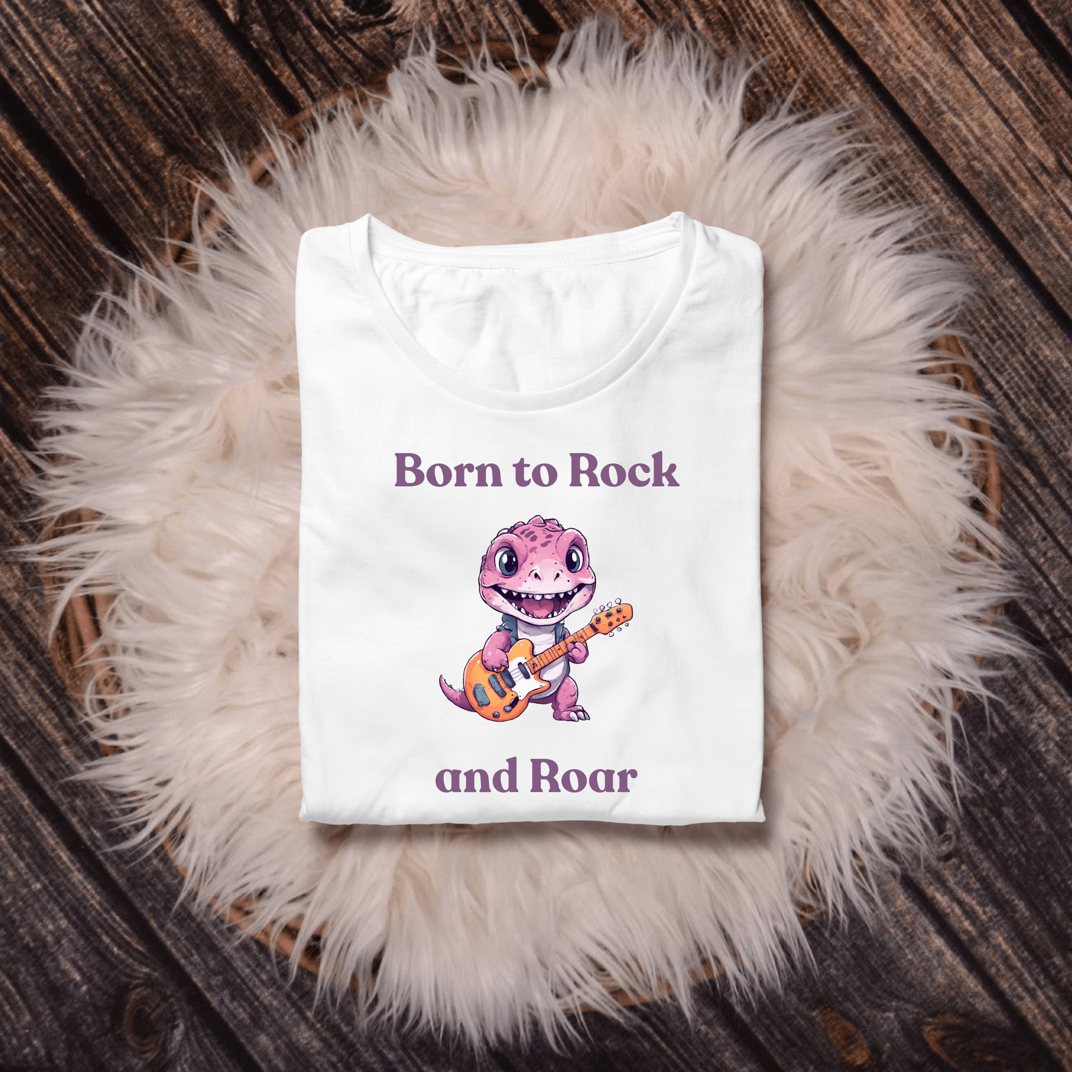 Fun children’s shirt showing a rocking pink dinosaur with big eyes and guitar.