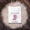 Fun children’s shirt showing a rocking pink dinosaur with big eyes and guitar.
