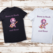 Black kids t-shirt with adorable dinosaur holding an orange electric guitar.