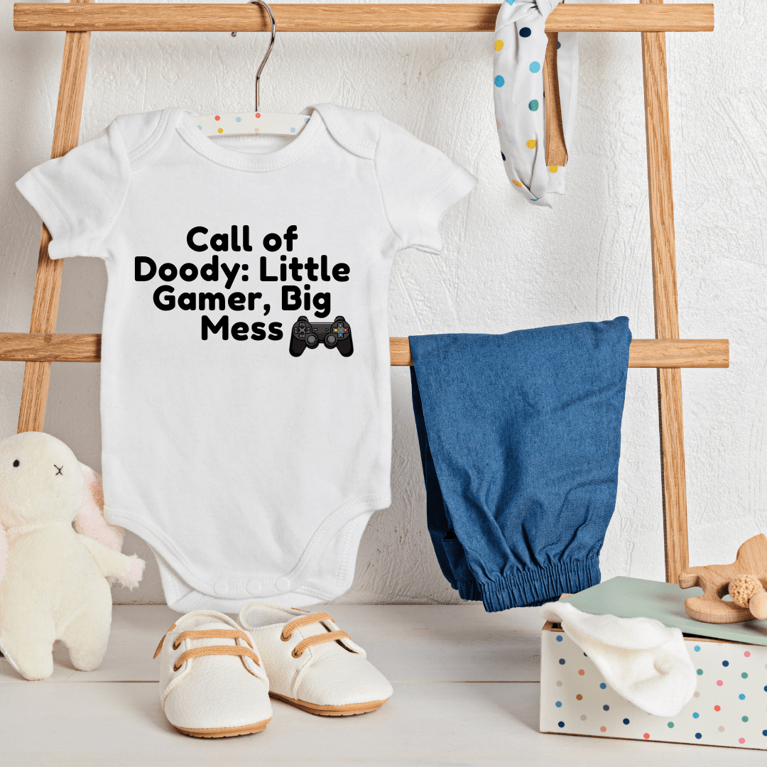 Call of Doody baby onesie hanging on wooden ladder with props