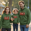 Parents and child in forest green Canada Day hoodies celebrating Canadian pride together
