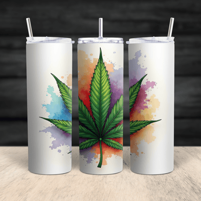 A stainless steel skinny tumbler featuring a vibrant watercolor cannabis leaf design displayed in a 360-degree view.
