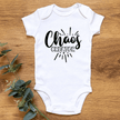 Close-up of funny Chaos Creator slogan on soft cotton baby bodysuit