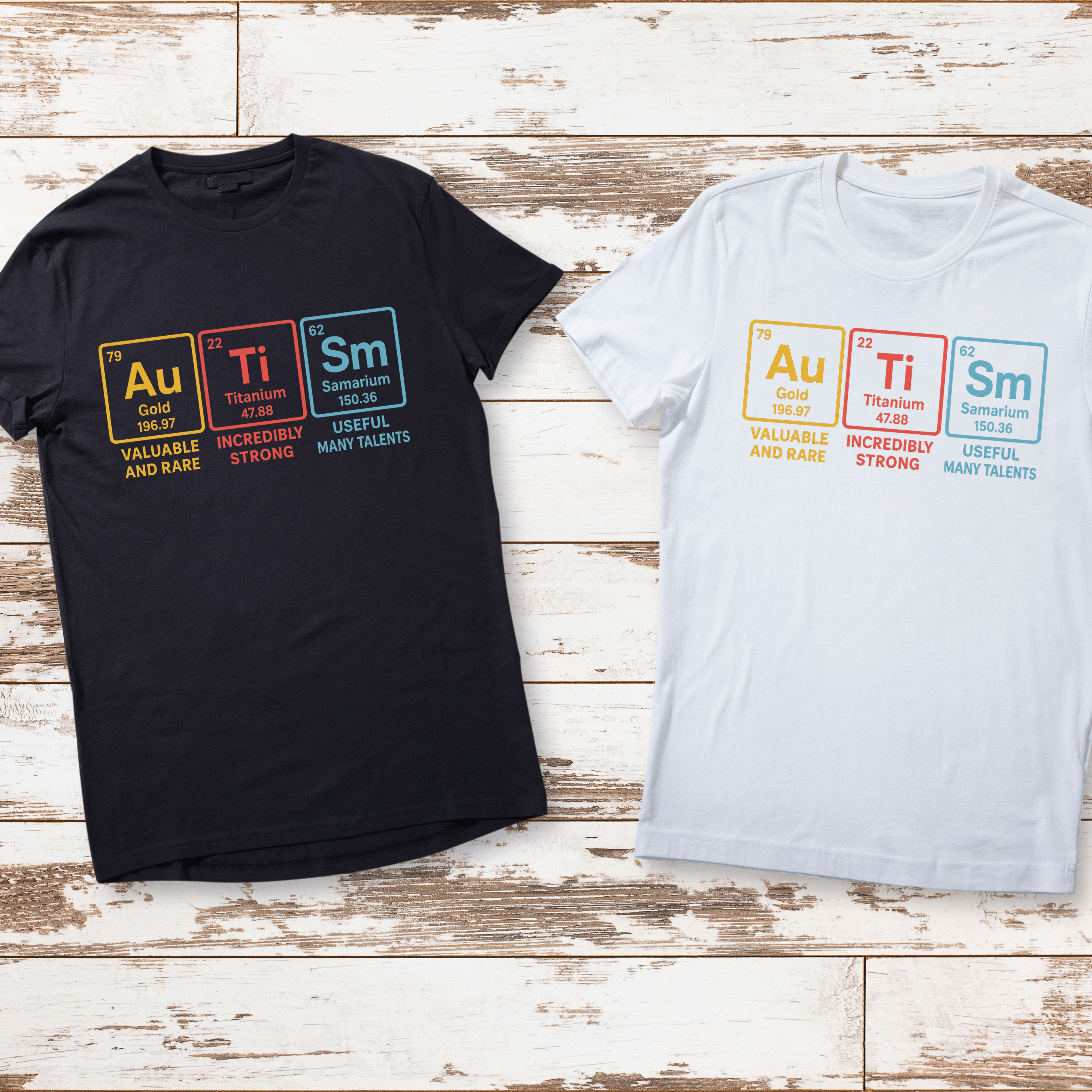 Black and white t-shirts with colorful text design on a wooden surface
