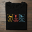 Black t-shirt with periodic table elements and descriptions on a wooden surface