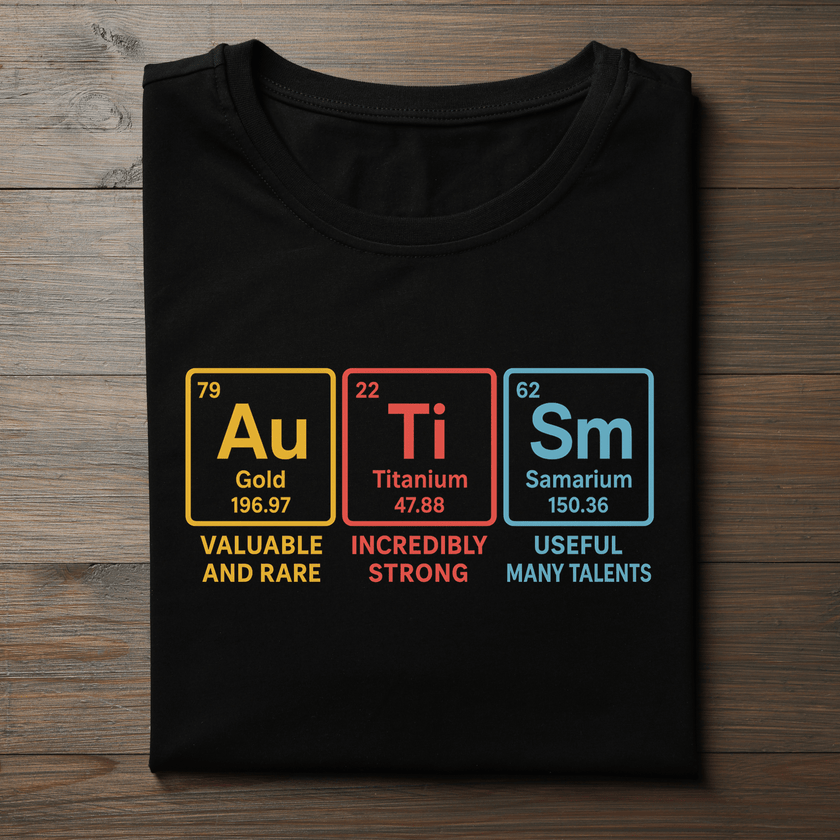 Black t-shirt with periodic table elements and descriptions on a wooden surface