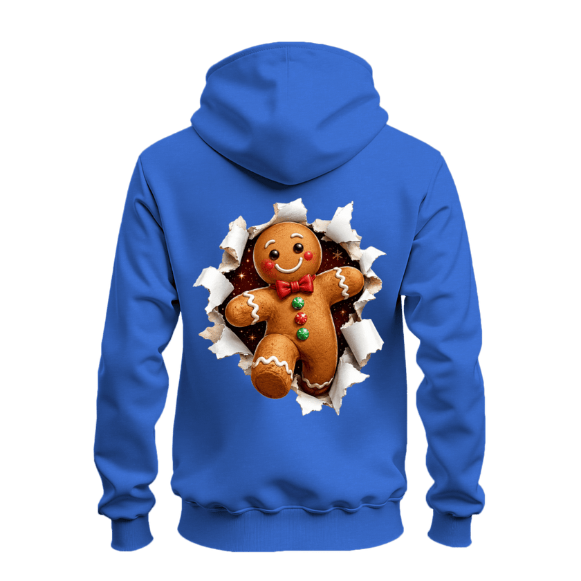 Back view of royal blue gingerbread Christmas hoodie featuring a large smiling gingerbread man bursting through torn paper.