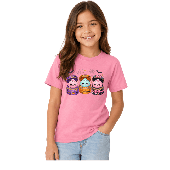 Pink youth Halloween graphic T shirt with adorable kawaii potion characters, bows, bats and playful spooky Halloween artwork.