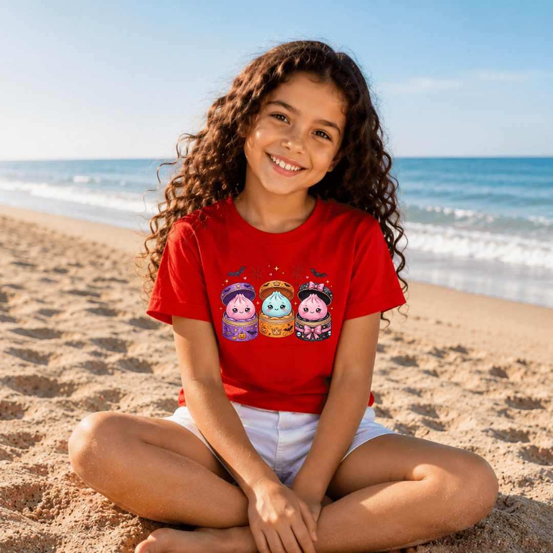 Red kids Halloween graphic T shirt with adorable kawaii potion characters, pumpkins, bats and playful seasonal artwork.