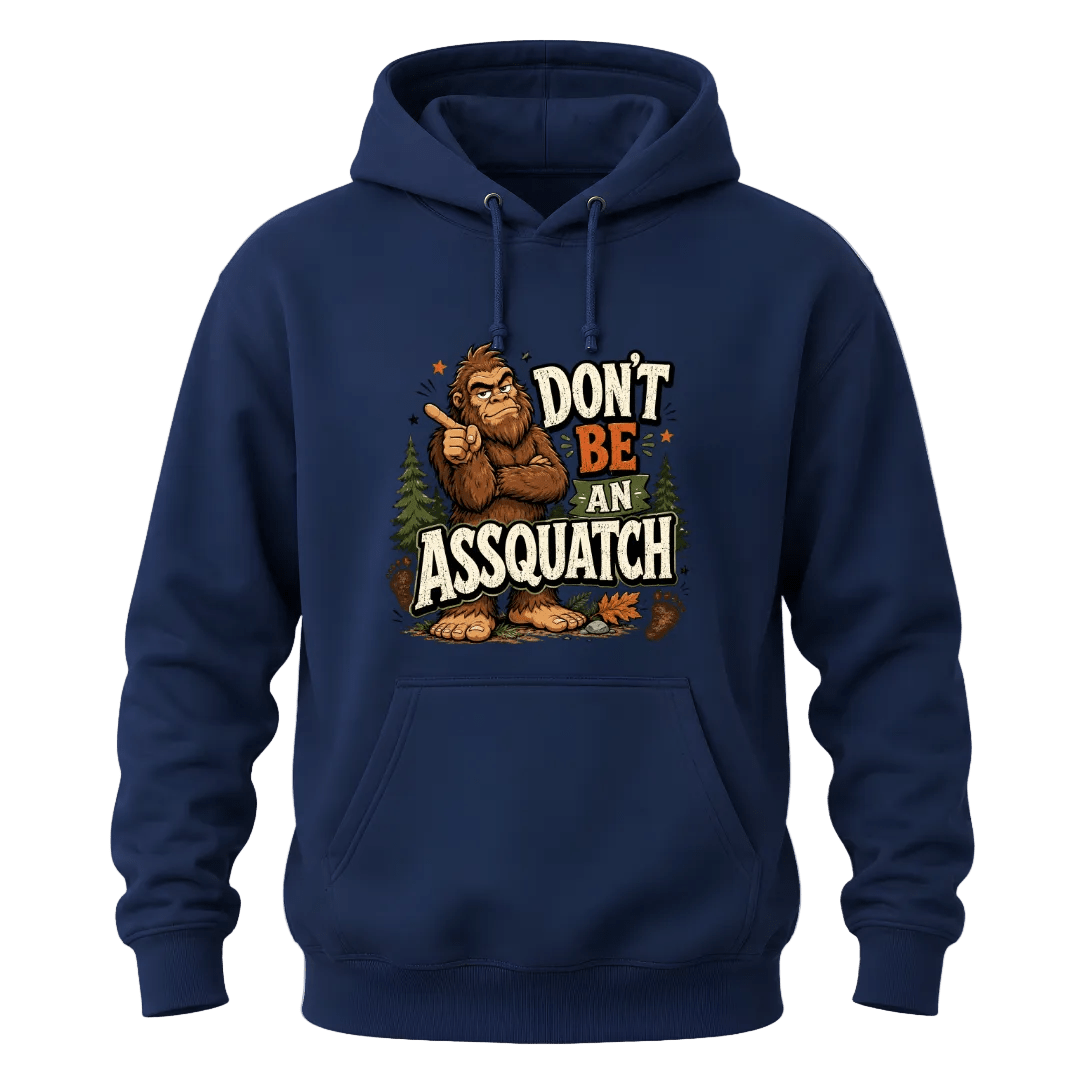 Navy hoodie with Don’t Be An Assquatch text, humorous Bigfoot character, pine trees, and bold outdoor style.