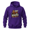 Purple graphic hoodie featuring a humorous Sasquatch design with pine trees, footprints, and Don’t Be An Assquatch lettering.