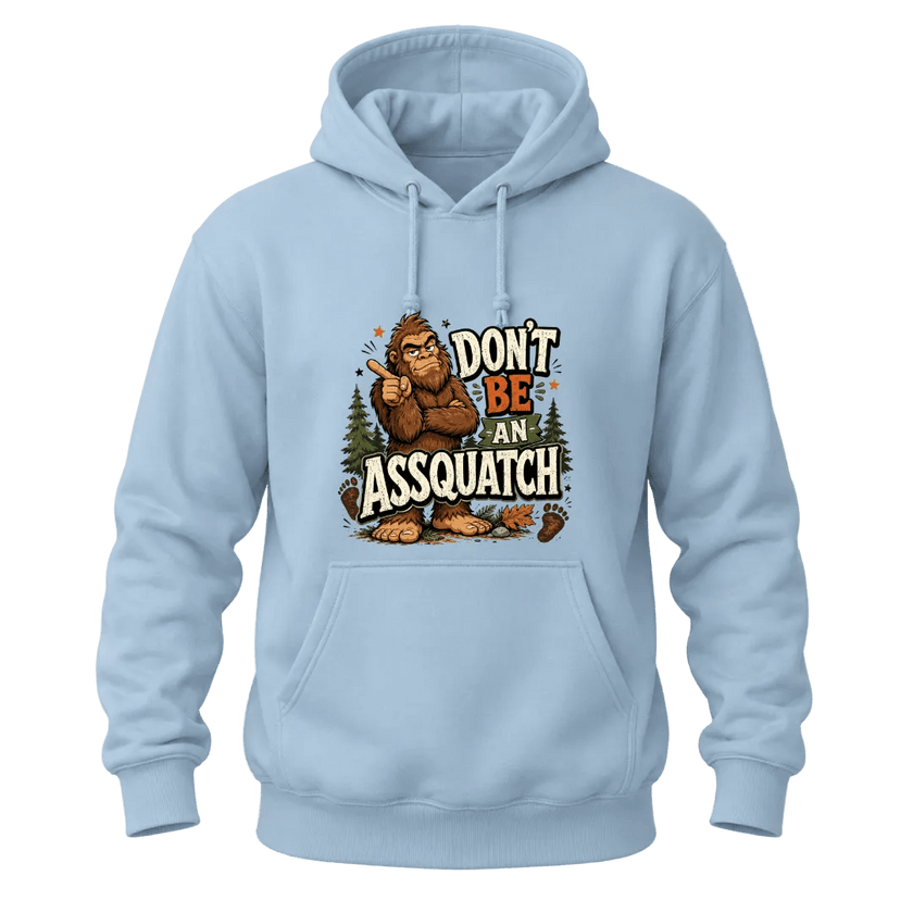Light Blue hoodie with a bold Don’t Be An Assquatch Sasquatch design, woodland graphics, and playful Bigfoot quote.