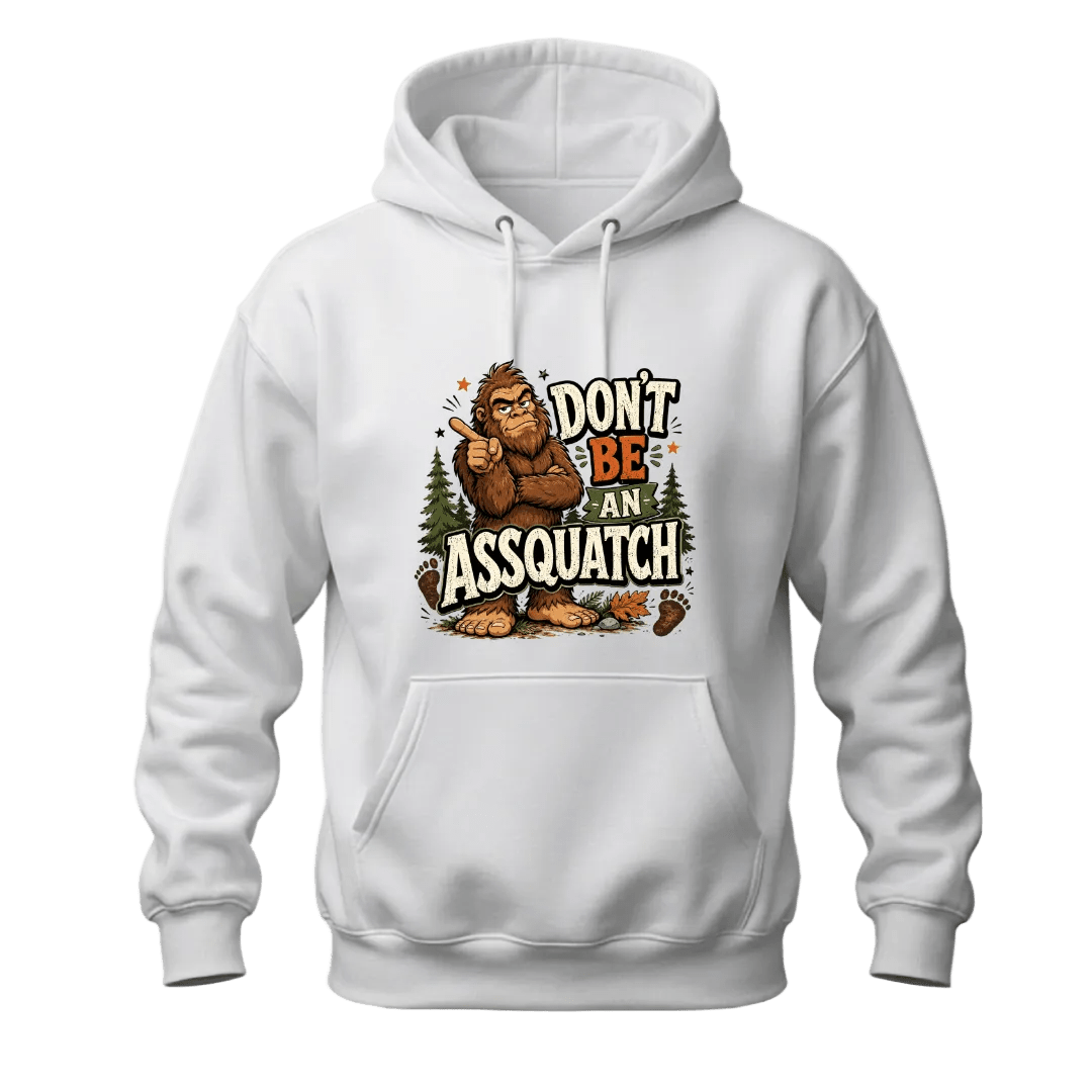 White hoodie featuring a funny Sasquatch graphic with Don’t Be An Assquatch text, forest trees, footprints, and bold outdoor humor.
