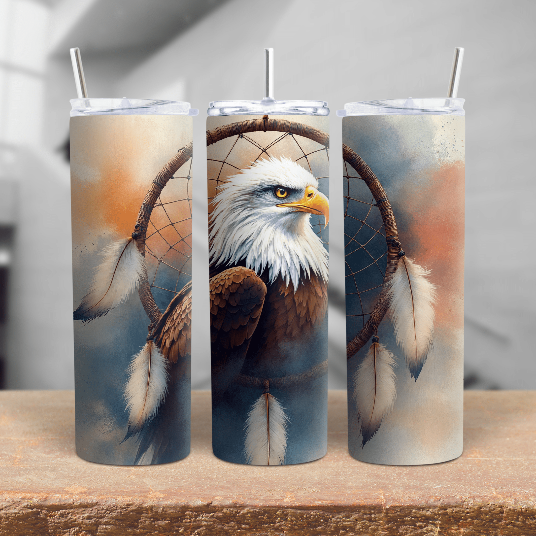 A 20oz and 30oz stainless steel tumbler featuring a detailed bald eagle inside a dreamcatcher with feathers.