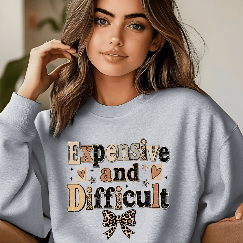 Light gray crewneck sweatshirt for women showcasing Expensive and Difficult statement graphic with leopard print bow and cozy casual fit.